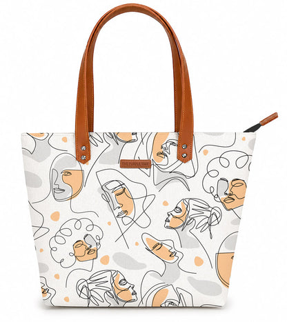 Tote bag with abstract face design and brown handle on a white background