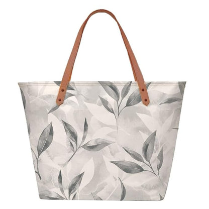 A trendy tote bag displaying a white and gray leaf print design.
