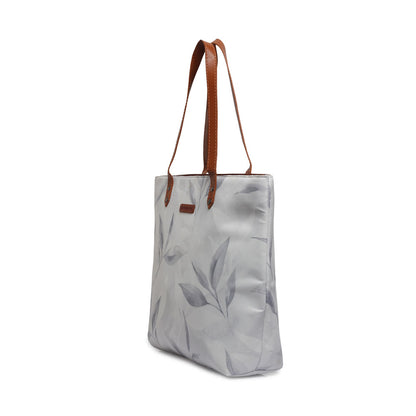 A stylish tote bag with a white and gray leaf print design. Perfect for carrying your essentials in style!