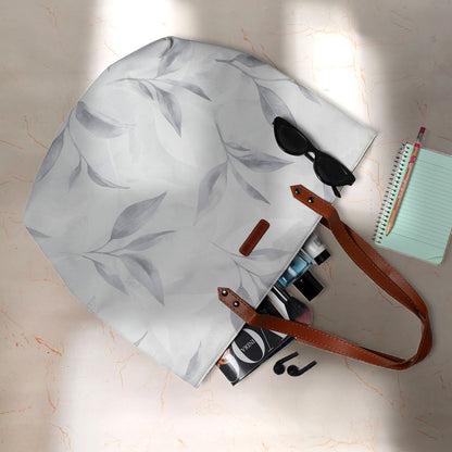 Stylish tote bag with white and gray leaf design.