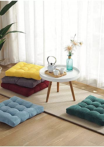 A set of colorful cushions arranged neatly on a floor.