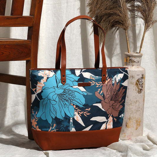 A floral bag resting on a chair beside a table.
