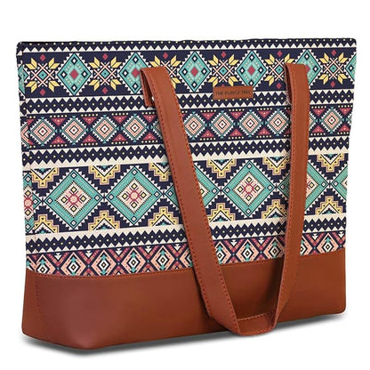  A stylish tribal print tote bag crafted from leather, featuring a chic brown handle for easy carrying.