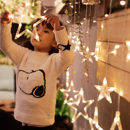 A row of lights hanging from above, brightening up the space with a magical ambiance.