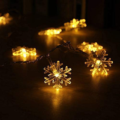 Beautiful snowflake LED lights illuminating the snowy holiday scene.