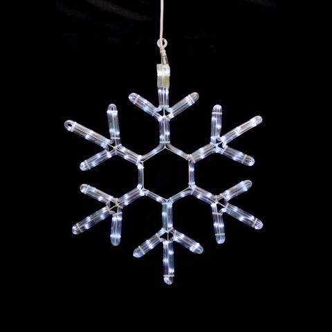 A bright snowflake radiating light, set against a deep black background, enhancing its intricate design and elegance.