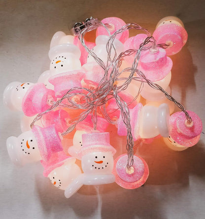 A vibrant string of pink and white Christmas lights, adding a joyful and decorative touch to the holiday season.