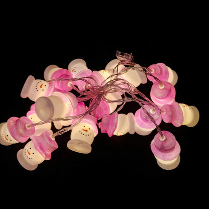 A string of pink and white Christmas lights glowing softly, creating a festive and cheerful atmosphere.
