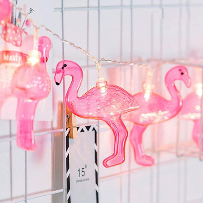 A charming arrangement of flamingos illuminated by pink lights, enhancing the playful ambiance of the scene.
