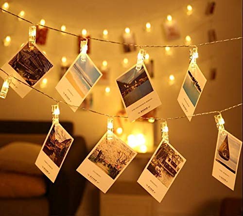 A collection of photos and artwork on a table.