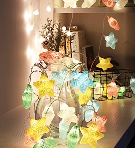  Inviting room showcasing a bed, a lamp, and a table embellished with a whimsical star garland.