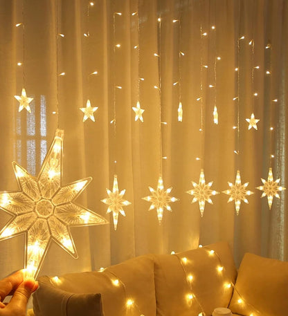 A person holding a star-shaped light-up curtain.