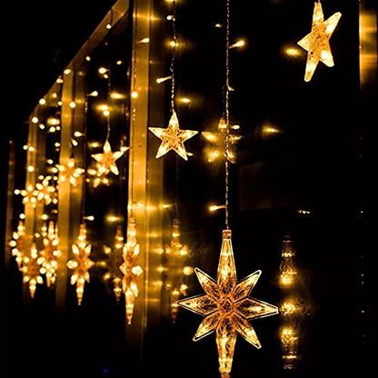  A window adorned with star-shaped decorations and glowing lights, creating a festive and cozy atmosphere.
