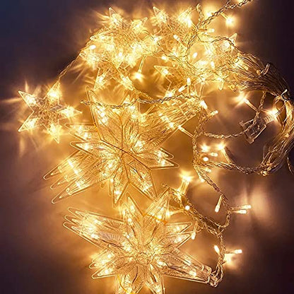 A person holding a star-shaped light-up curtain.