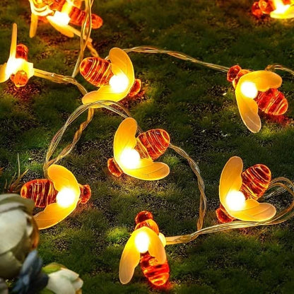 Bees swarming around a string of lights, creating a beautiful and lively display in the garden.