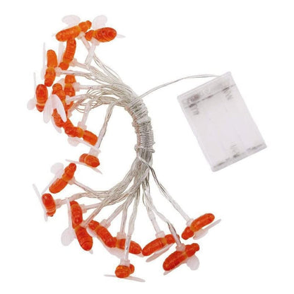 Festive orange lights on white cord