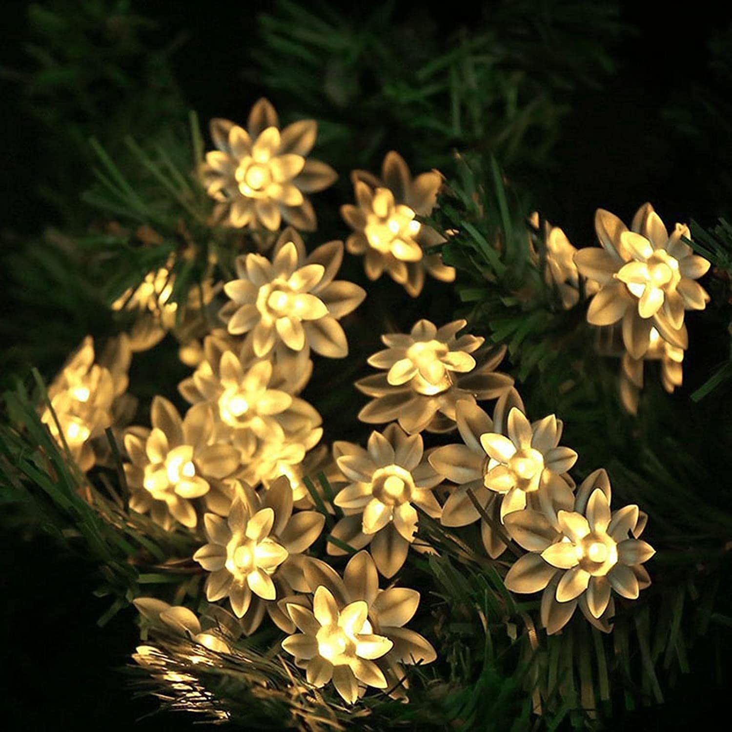  White flowers decorating a Christmas tree.