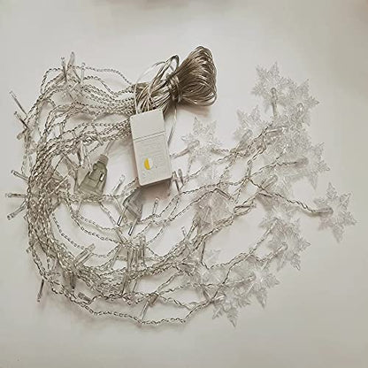  A vibrant Christmas tree decorated with glowing lights and a star garland, creating a warm holiday ambiance.