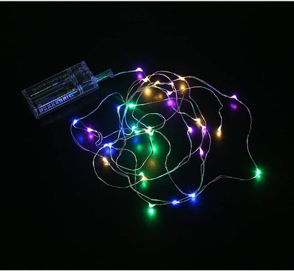 Colorful string lights against black background, creating a vibrant and festive atmosphere.