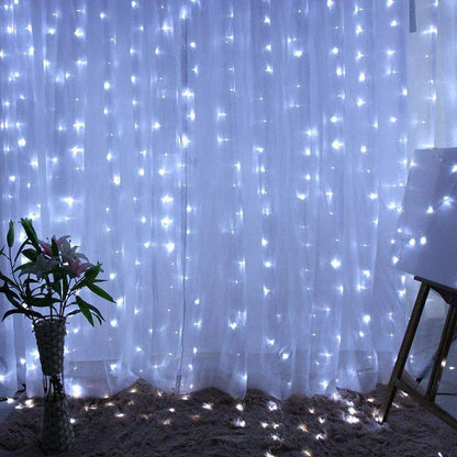 Elegant white curtain adorned with sparkling lights, adding a touch of charm.