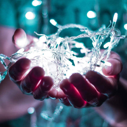 Soft white curtain with twinkling lights, casting a warm and inviting glow.