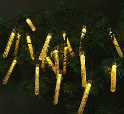 Vibrant LED icicle lights shining on a Christmas tree.