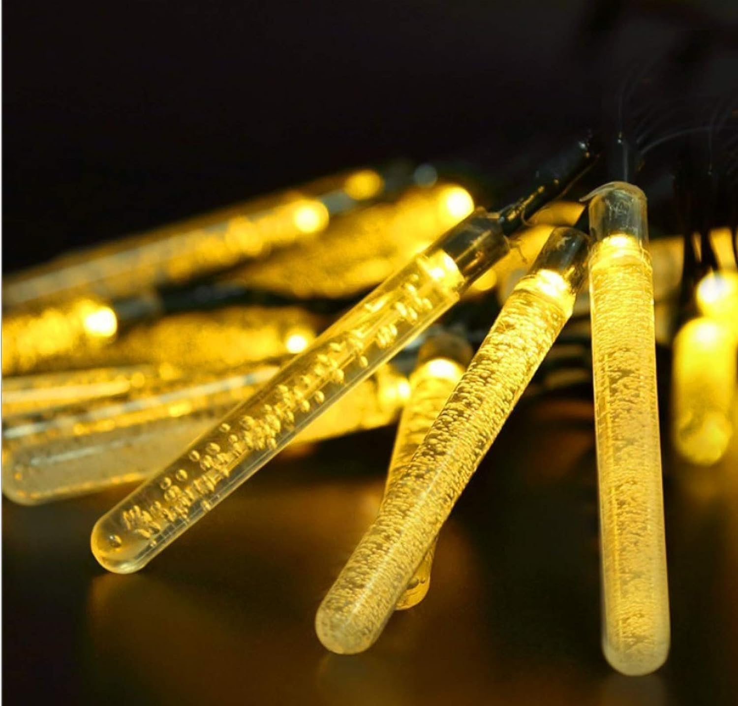 Yellow string lights glowing brightly in the dark.