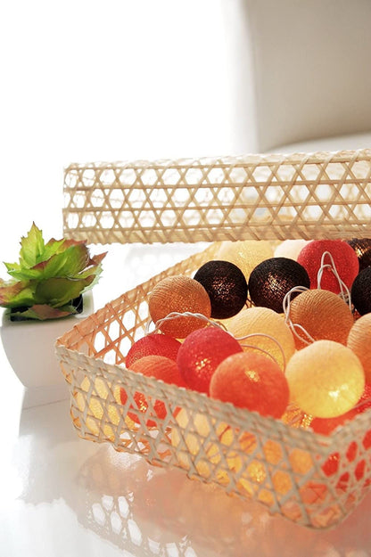 Colorful ball string lights hanging on a wall, adding a festive touch to the room decor.
