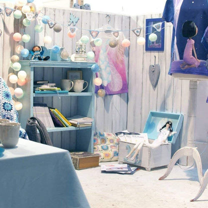 Festive ball string lights in various colors, brightening up the wall they are hung on.