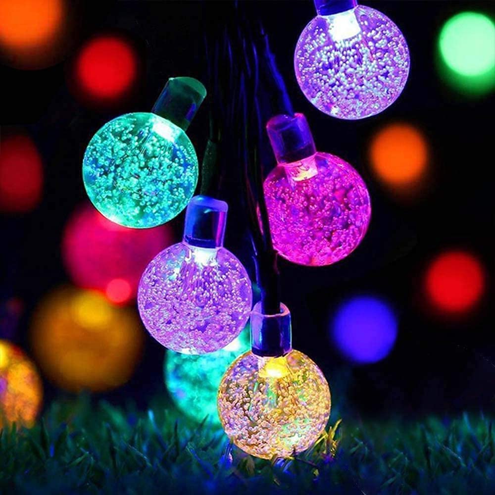  A string of colorful lights illuminating a decorative vase.