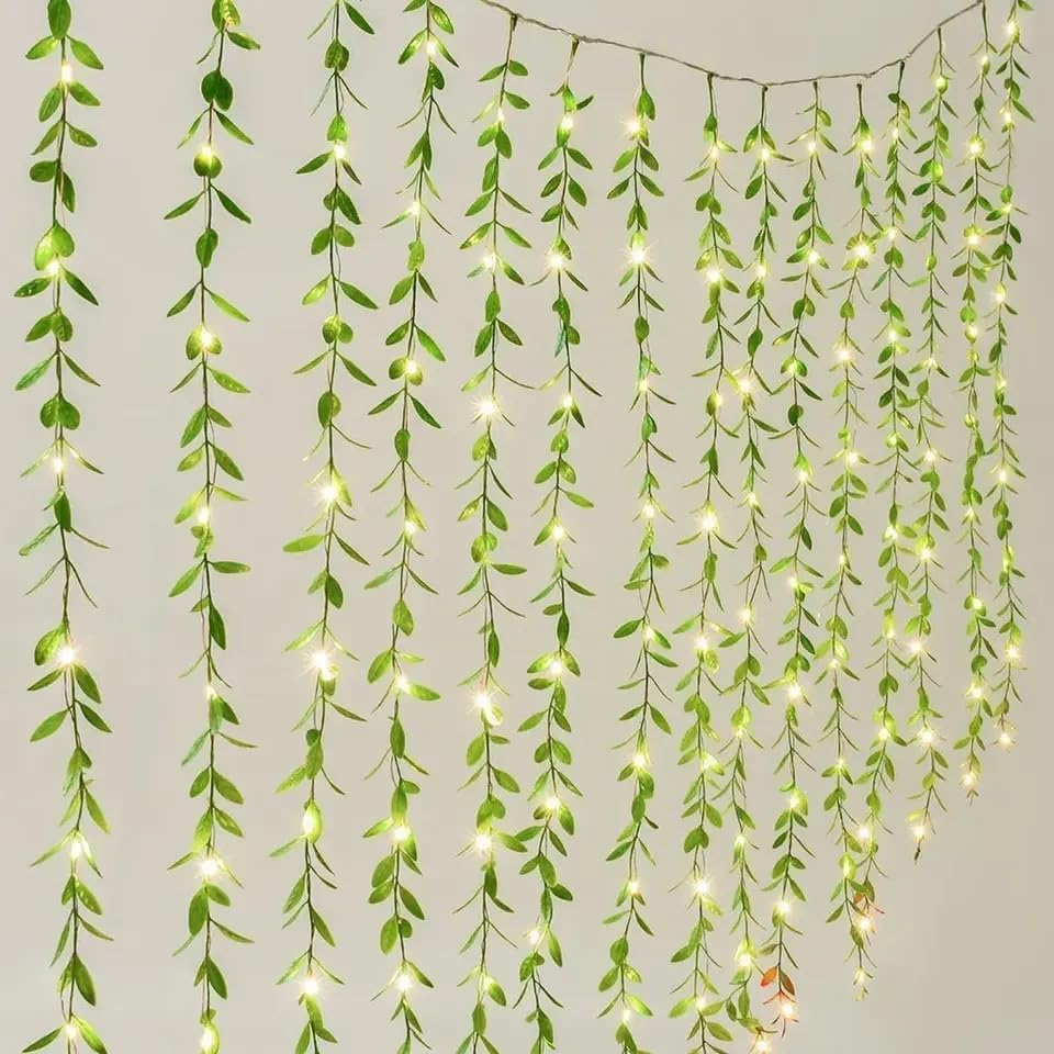 Green curtain with hanging lights, creating a cozy and inviting atmosphere.
