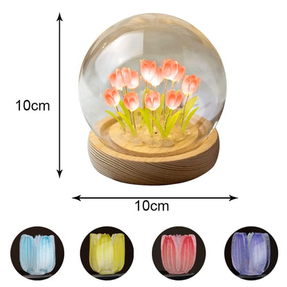 A glass globe encasing stunning blue flowers, offering a unique and artistic representation of floral beauty in a contained space.