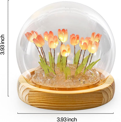 A glass dome showcasing a colorful bouquet of flowers, elegantly displayed to enhance the aesthetic of any setting.