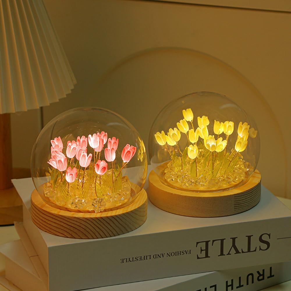 A transparent glass dome filled with an assortment of fresh flowers, elegantly preserving their natural charm and vibrancy.
