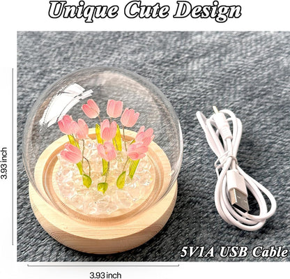 A glass ball containing a vibrant arrangement of colorful flowers, showcasing nature's beauty in a delicate sphere.
