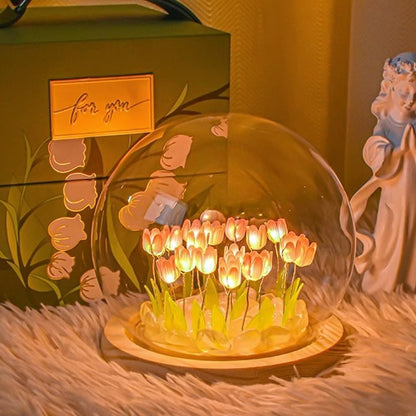 A beautifully crafted glass dome encasing a variety of blooming flowers, highlighting their intricate details and colors.