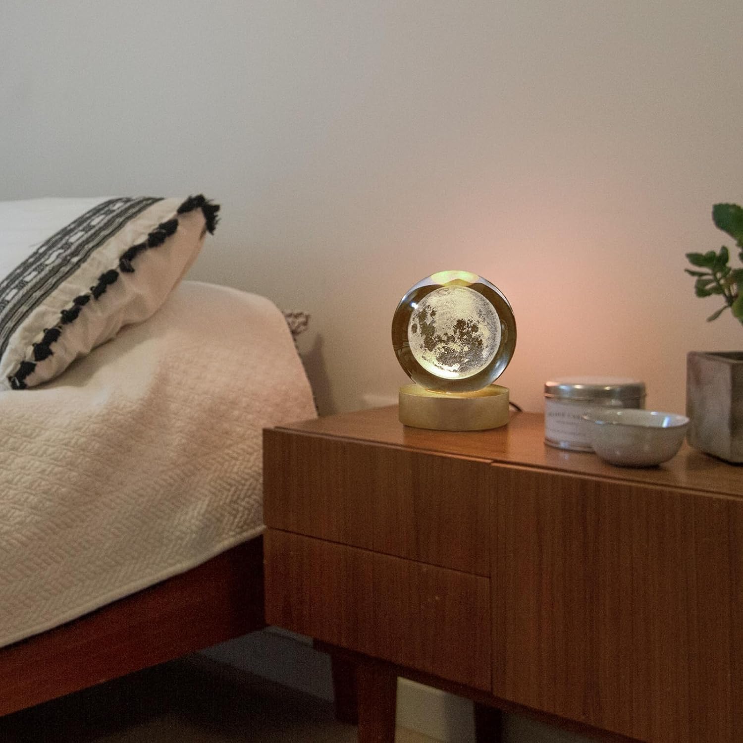 A moon ball placed on a table, adorned with fresh flowers, bringing a touch of nature indoors.