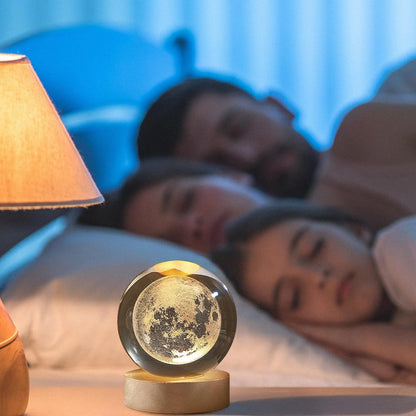 A moon ball atop a table, with lovely flowers around it, enhancing the cozy and artistic vibe of the space.