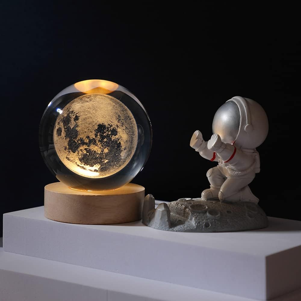 A decorative moon ball sits on a table, complemented by vibrant flowers, adding charm to the setting.
