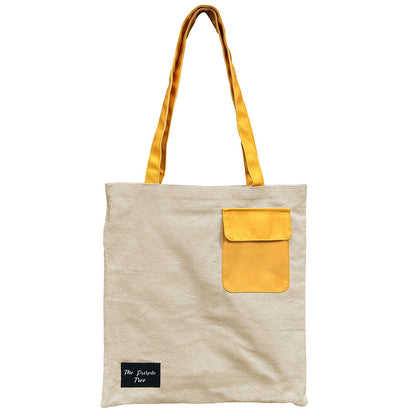 Image of a tote bag with a yellow pocket.