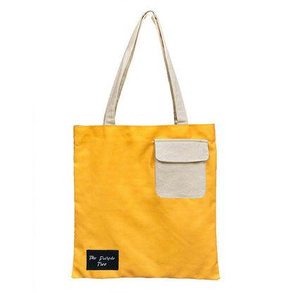 Yellow tote bag with white pocket, perfect for carrying essentials on the go.