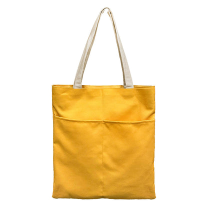 Stylish yellow tote bag featuring a convenient white pocket for organization.