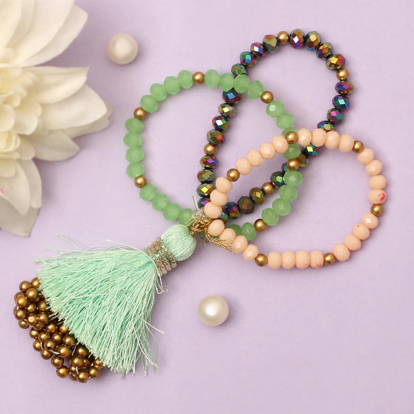  A stylish bracelet with colorful beads and a tassel resting on a wooden table, adding a pop of color to the scene.