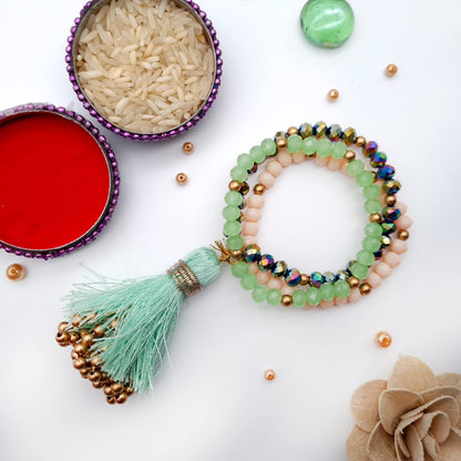  A charming bracelet with a tassel and beads, artfully placed on a table for display.