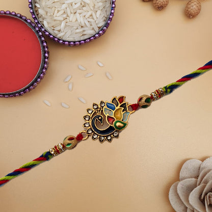  Rakhi adorned with a striking gold and red pattern.