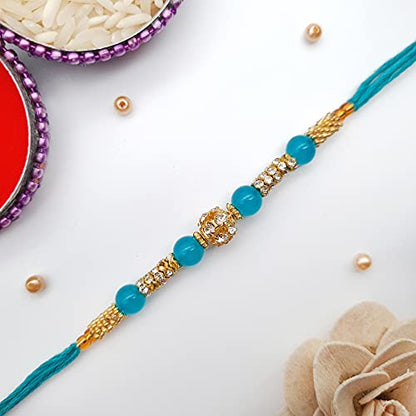  Rakhi with crystal bead, featuring blue and gold colors for Raksha Bandhan.