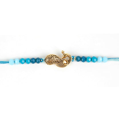  A stylish blue string adorned with a gold clasp and a lovely gold charm attached.