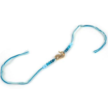  A vibrant blue string with a gleaming gold clasp and a decorative gold charm.