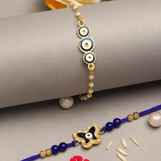 Two blue and gold rakhi bracelets with evil eye charms, perfect for celebrating Raksha Bandhan.