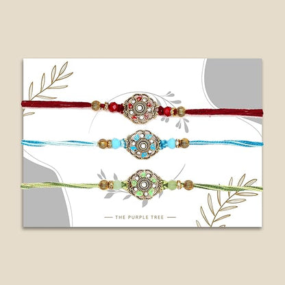 Three colorful rakhi's with gold and green beads